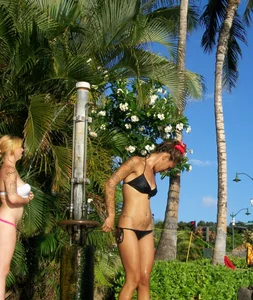 Beach shower girl with cute little ass in tiny black bikini