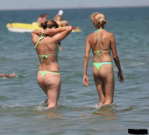 A bunch of sexy beach voyeur babes in bikinis, thongs and topless