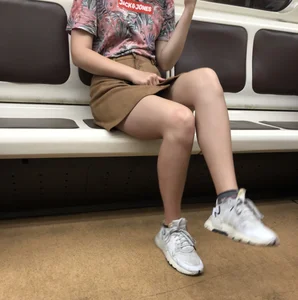 Amazing Hot Girl in a Skirt and Sneakers Sitting Cross-Legged in the Subway Train and on the Escalator Candid Photos Gallery