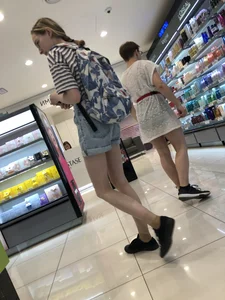 Girl in Blue Denim Shorts with Very Skinny Legs Store Candid