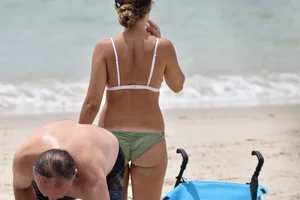 Two sexy ass girls on the beach in bikinis