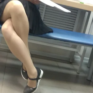 Girl in a Skirt and Pantyhose Sitting with Legs Crossed Hot Closeup Creepshot