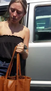 Pretty babe with small boobs in black top getting out of her car