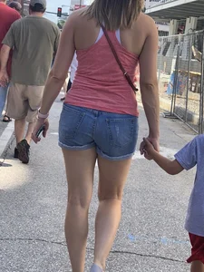 Bunch of girls in various outfits at a Cardinals baseball game