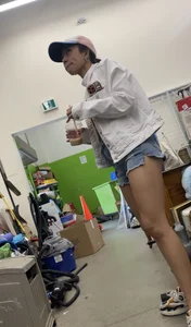 Tight bum hanging out of jean shorts in thrift shop