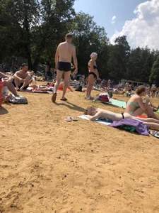 Topless Skinny Girl With Very Pale Skin Lying on a Beach on Her Tummy With Slightly Spread Legs Creepshots Gallery