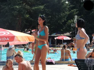 Tall and skinny brunette babe at the pool in a teal thong bikini
