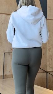 Following the blonde with Fake lashes in green leggings
