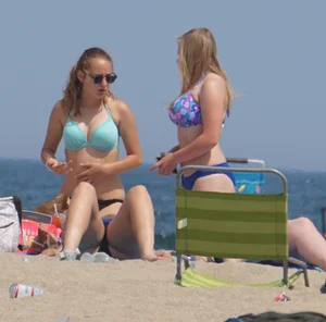 3 girls on the beach in bikinis with big boobs, one brunette and two blondes