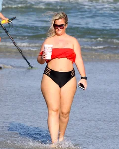 Thick BBW blonde lady in a bikini at the beach