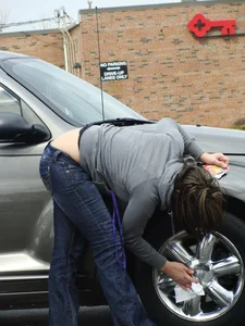 Girl cleaning her car in jeans and showing some cheetah print underwear