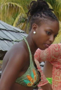Sexy black babe in various bikinis on the beach while on vacation