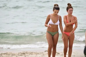 Two sexy ass girls on the beach in bikinis