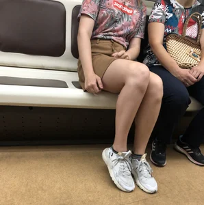Amazing Hot Girl in a Skirt and Sneakers Sitting Cross-Legged in the Subway Train and on the Escalator Candid Photos Gallery