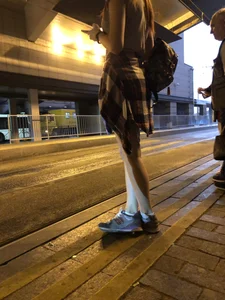 Cute Teen in Shorts on the Tram Stop