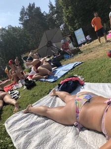 Female Legs and Ass in a Swimsuit on the Grass in a Park