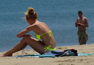 Sexy ass blonde milf on the beach in a thong with cameltoe and bending over