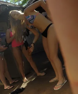 Two nice asses in thong bikinis at a Disney waterpark