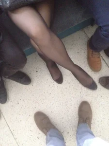 Legs of a Young Shoeless Girl in Black Pantyhose