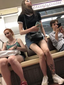 Two Girls With Hot Long Legs in Mini Shorts and Sneakers in the Subway Train Candid Photo Gallery