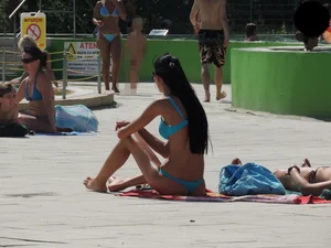 Tall and skinny brunette babe at the pool in a teal thong bikini