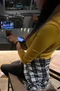 Girl in leggings with very slim legs sitting on a bar stool creepshot