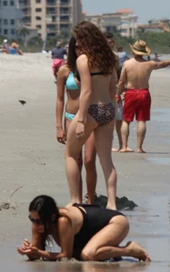 Brunette and redhead on the beach in bikinis looking sexy