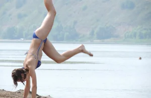 Skinny teen having fun in her little England bikini
