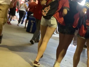 Bunch of girls in various outfits at a Cardinals baseball game