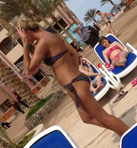 Sexy blonde babe in a bikini at the pool