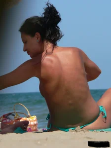 Bunch of sexy babes on the beach topless and in thong bikinis