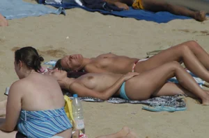 Topless girls on a beach in Barcelona