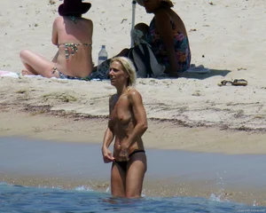 Small boobed topless milf on the beach