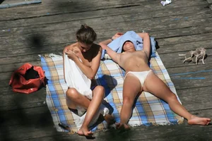 Two teens stripping and going topless to tan