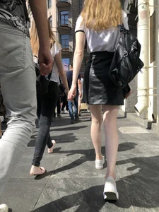 Hot redhead chick wearing leather skirt, nice pale legs