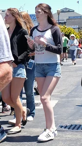 Cute girl walking in short jean shorts