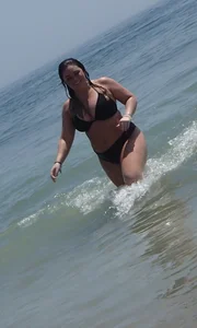 Thick beach babe with big tits in a thong bikini