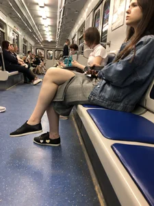 Girl Sitting with Crossed Legs in the Subway Train Candid