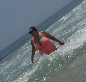 Thick lady on the beach with huge tits