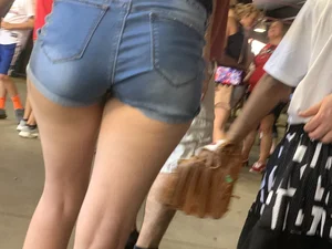 Bunch of girls in various outfits at a Cardinals baseball game