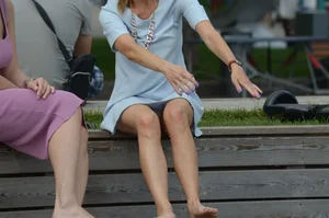 Blonde milf upskirted showing white panties and some pubes