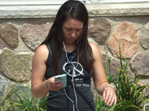 Thick brunette listening to music in shorts
