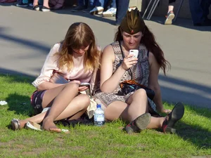 Girls Sitting on the Lawn in Skirts City Candid