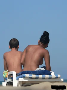 Hot ass topless beach girl with great tits lets her little brother oil up her ass in thong bikini