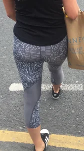 Sexy girl walking in grey patterned leggings with friend in tight jeans