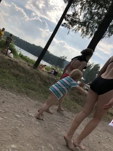 Cute Barefoot Girl in a Black Body Swimsuit Walking on a Road