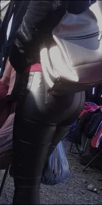 Milf shows off her shapely ass in her leather pants at the market