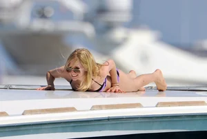 Avril Lavinge looking sexy in purple bikini on a boat