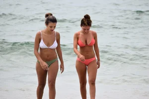 Two sexy ass girls on the beach in bikinis