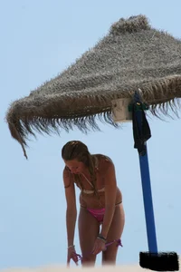 Hot beach girl undressing and going topless